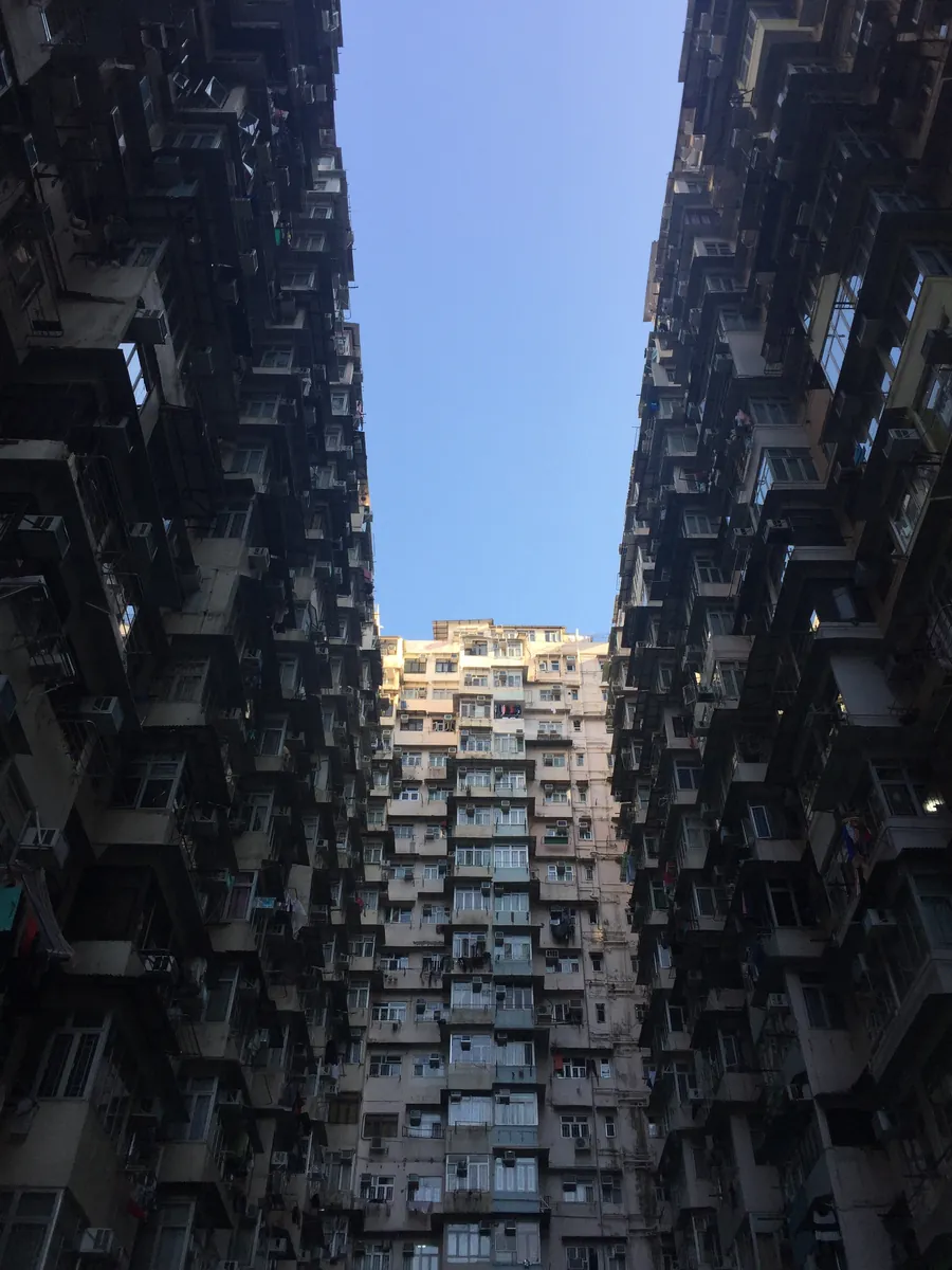 Looking up at the densely packed, colour-blocked apartment towers of the